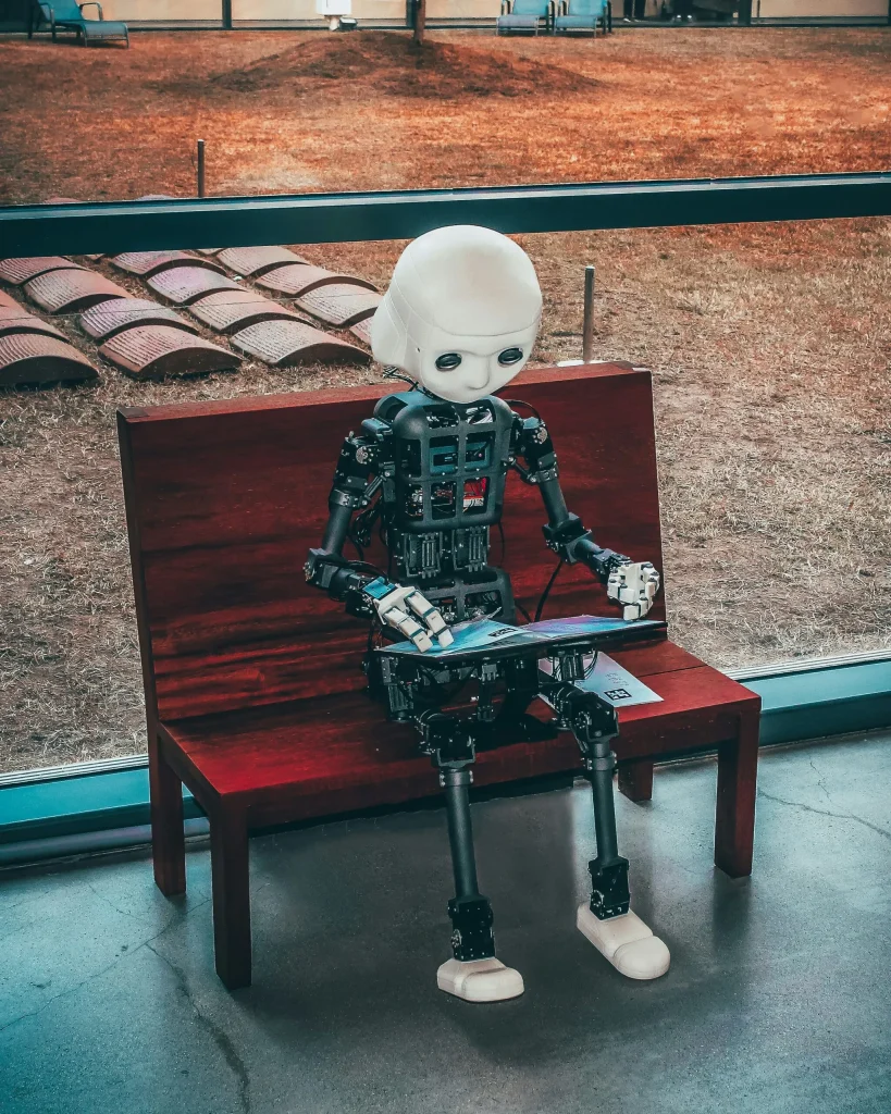 black-and-white-robot-toy-on-red-wooden-table-scaled