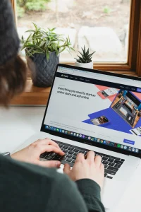 person-using-macbook-pro-on-white-table-scaled