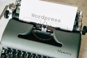 black-typewriter-on-green-table-scaled