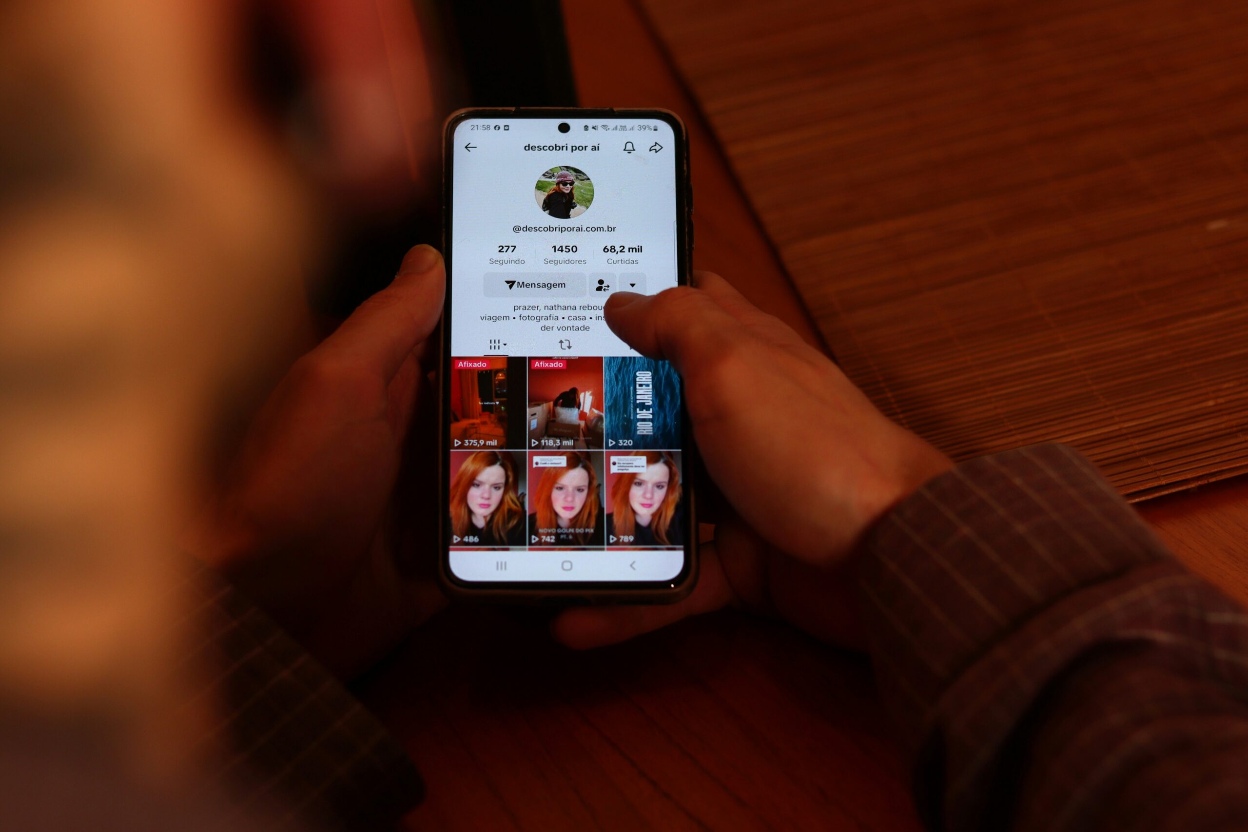 A-person-holding-a-cell-phone-with-multiple-pictures-on-the-screen-scaled